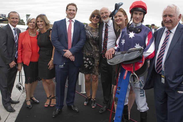 Leon Macdonald, jockey Chad Schofield & connections after Go Indy Go's win in the 2014 Champagne Stakes