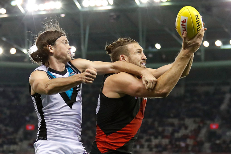 CALE HOOKER of the Bombers and Jasper Pittard of the Power compete for the ball during the 2017 AFL match between the Essendon Bombers and the Port Adelaide Power at Etihad Stadium in Melbourne, Australia. CALE HOOKER of the Bombers and Jasper Pittard of the Power compete for the ball during the 2017 AFL match between the Essendon Bombers and the Port Adelaide Power at Etihad Stadium in Melbourne, Australia.