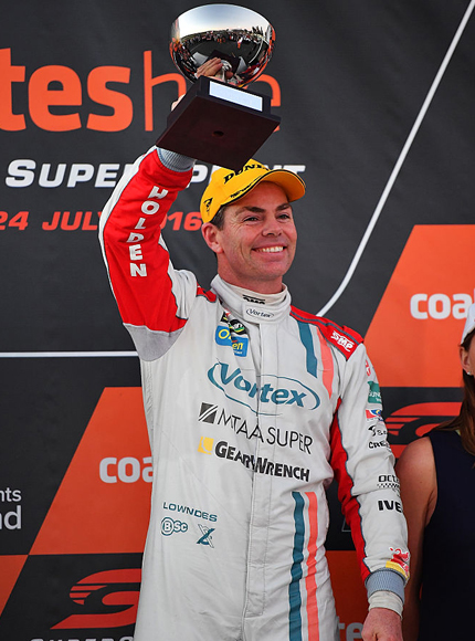 CRAIG LOWNDES driver of the #888 TeamVortex Holden Commodore VF celebrates on the podium after race 1 for the V8 Supercars Ipswich Supersprint in Ipswich, Australia.