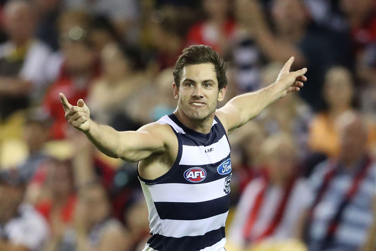 DANIEL MENZEL of the Cats celebrates after kicking a goal during the AFL match between the Geelong Cats and the Melbourne Demons at Etihad Stadium in Melbourne, Australia.
