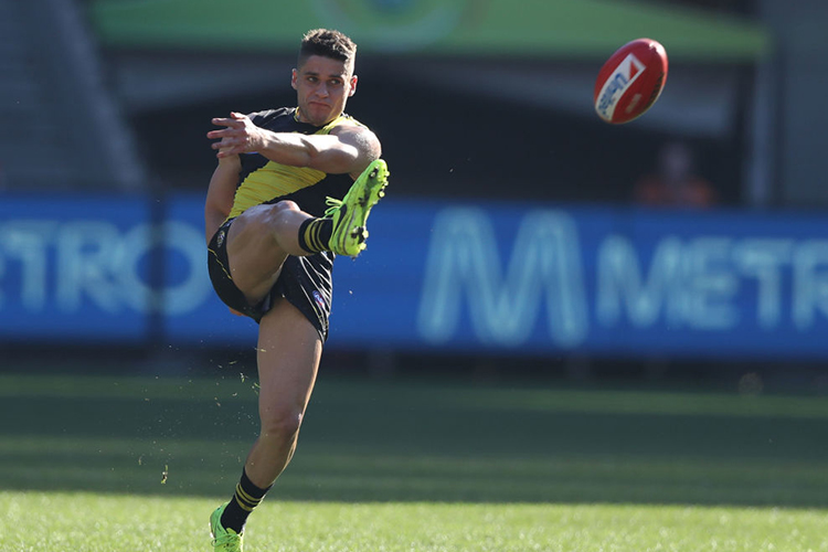 DION PRESTIA of the Tigers kicks the ball during the AFL match between the Richmond Tigers and the Sydney Swans at MCG in Melbourne, Australia.