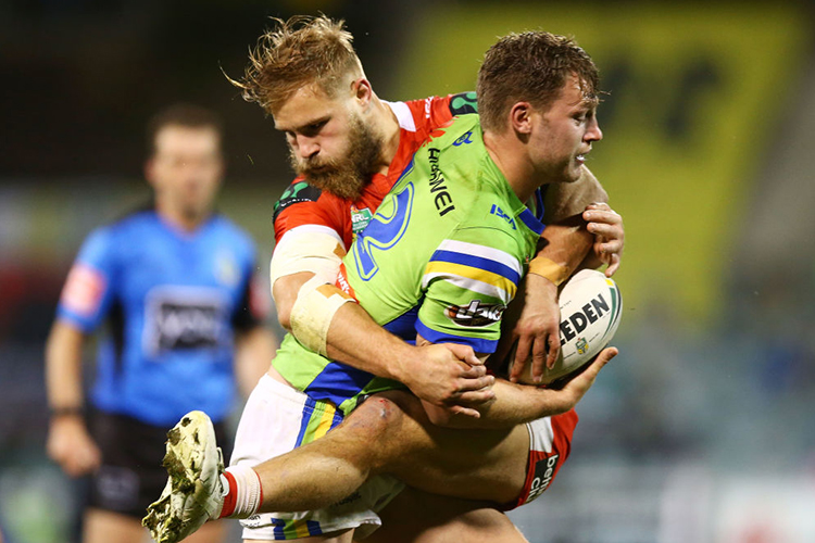 ELLIOT WHITEHEAD of the Raiders is tackeld by Jack De Belin of the Dragons during the NRL match between the Canberra Raiders and the St George Illawarra Dragons at GIO Stadium in Canberra, Australia.