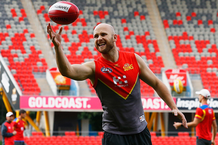 GARY ABLETT juggles the ball during a Gold Coast Suns AFL training session at Metricon Stadium in Gold Coast, Australia.