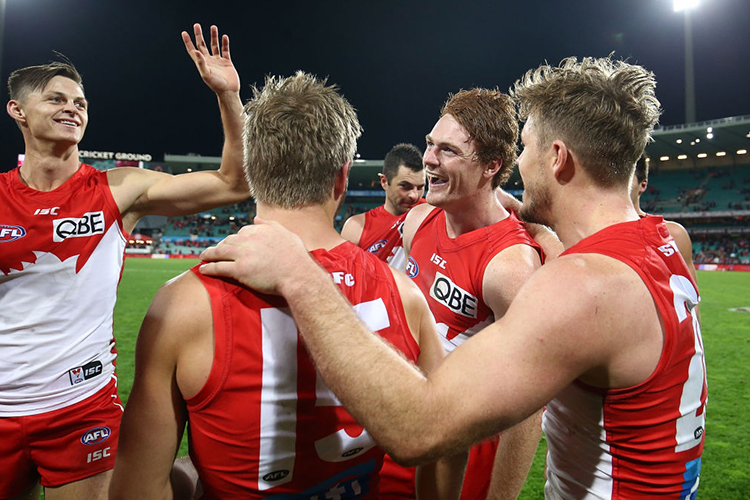 GARY ROHAN of the Swans celebrates with team mates after kicking a goal to win the match during the AFL match between the Sydney Swans and the Essendon Bombers at SCG in Sydney, Australia.