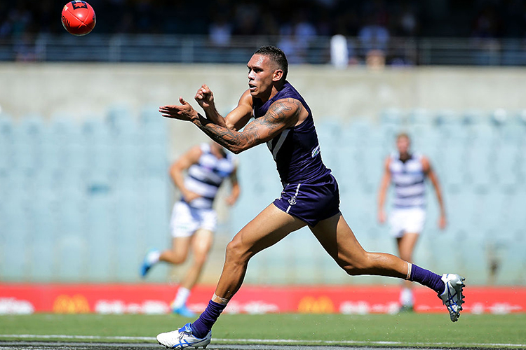 HARLEY BENNELL of the Dockers handballs during the 2016 NAB Challenge match between the Fremantle Dockers and the Geelong Cats at Domain Stadium in Perth, Australia.