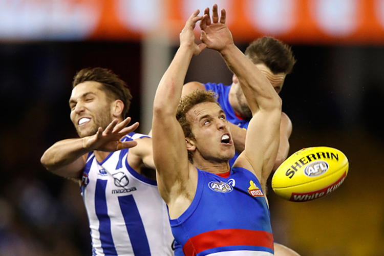 Jamie Macmillan of the Kangaroos, MITCH WALLIS of the Bulldogs and Matthew Suckling of the Bulldogs compete for the ball during the 2017 AFL match between the Western Bulldogs and the North Melbourne Kangaroos at Etihad Stadium in Melbourne, Australia. Jamie Macmillan of the Kangaroos, MITCH WALLIS of the Bulldogs and Matthew Suckling of the Bulldogs compete for the ball during the 2017 AFL match between the Western Bulldogs and the North Melbourne Kangaroos at Etihad Stadium in Melbourne, Australia.