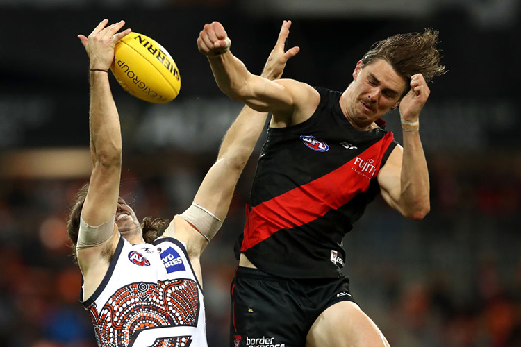 JOE DANIHER of the Bombers spoils the ball over PHIL DAVIS of the Giants during the AFL match between the Greater Western Sydney Giants and the Essendon Bombers at Spotless Stadium in Sydney, Australia.