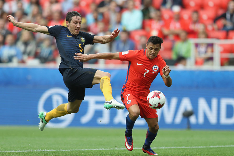 MARK MILLIGAN of Australia attempts to stop ALEXIS SANCHEZ of Chile from scoring during the FIFA Confederations Cup Russia 2017 match between Chile and Australia at Spartak Stadium in Moscow, Russia. MARK MILLIGAN of Australia attempts to stop ALEXIS SANCHEZ of Chile from scoring during the FIFA Confederations Cup Russia 2017 match between Chile and Australia at Spartak Stadium in Moscow, Russia.