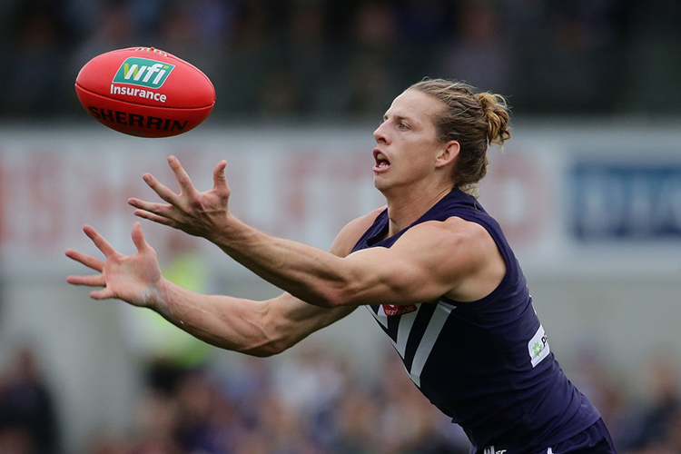 PERTH, WESTERN AUSTRALIA - JULY 16: Nat Fyfe of the Dockers marks the ball during the round 17 AFL match between the Fremantle Dockers PERTH, WESTERN AUSTRALIA - JULY 16: Nat Fyfe of the Dockers marks the ball during the round 17 AFL match between the Fremantle Dockers
