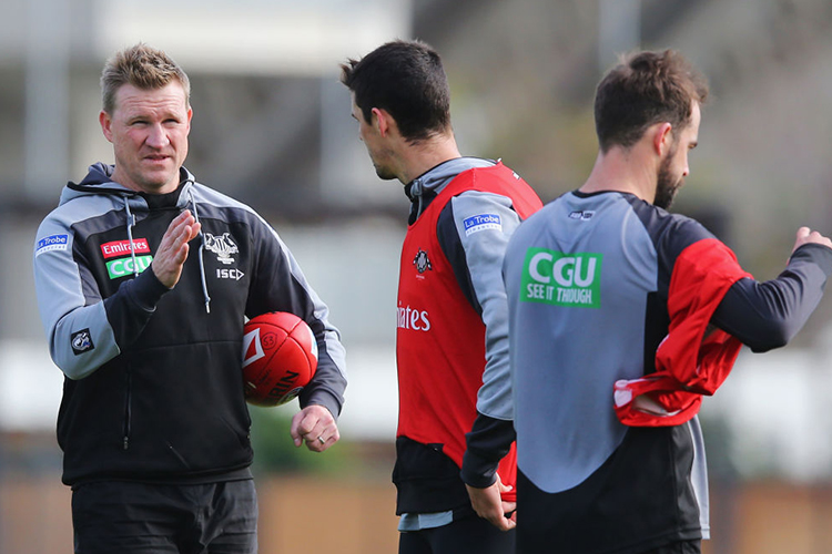 Magpies head coach NATHAN BUCKLEY speaks to Scott Pendlebury of the Magpies during a Collingwood Magpies AFL training session at Gosch's Paddock in Melbourne, Australia.