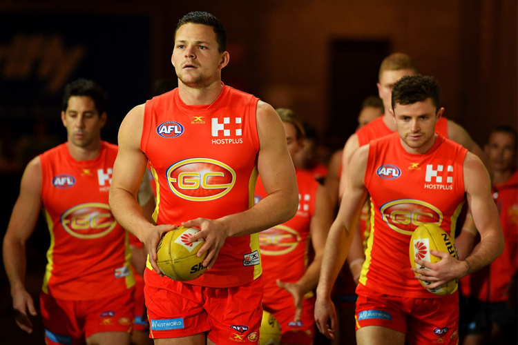 STEVEN MAY of the Suns leads his team mates onto the ground during the AFL match between the Port Adelaide Power and the Gold Coast Suns at Adelaide Oval in Adelaide, Australia.