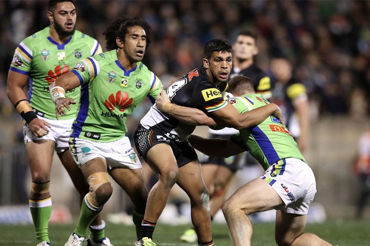 TYRONE PEACHEY of the Panthers is tackled during the NRL match between the Penrith Panthers and the Canberra Raiders at Carrington Park in Bathurst, Australia.