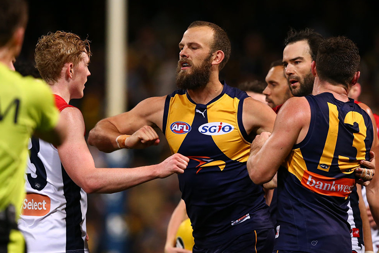 WILL SCHOFIELD of the Eagles raises his forearm towards Clayton Oliver of the Demons at the end of the second quarter during the AFL match between the West Coast Eagles and the Melbourne Demons at Domain Stadium in Perth, Australia.