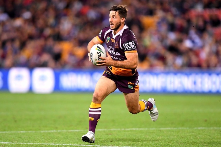 BEN HUNT of the Broncos runs with the ball during a NRL match at Suncorp Stadium in Brisbane, Australia