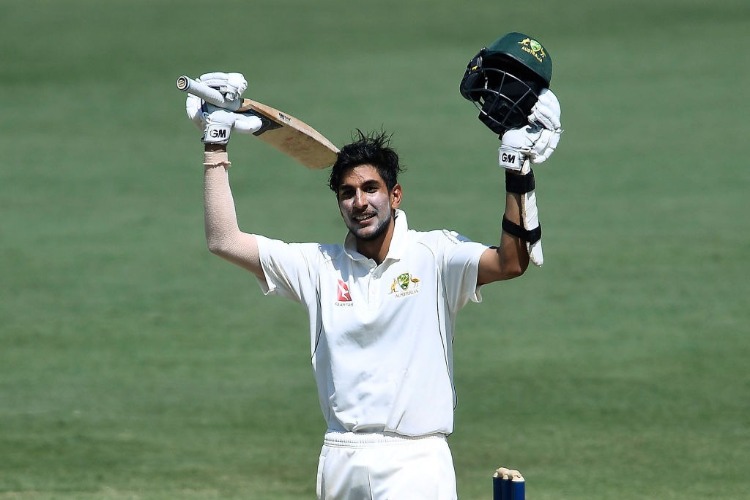 JASON SANGHA of CA XI celebrates after reaching a century during a tour match against England at Tony Ireland Stadium in Australia.
