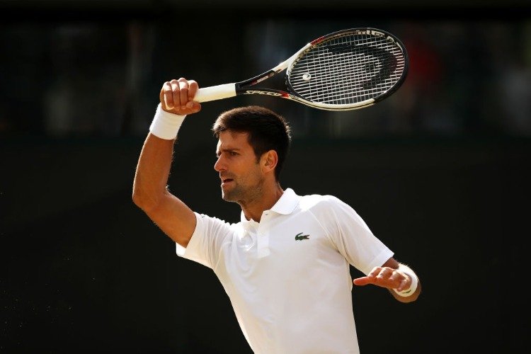 NOVAK DJOKOVIC of Serbia plays a forehand against Tomas Berdych of The Czech Republic in the Wimbledon Lawn Tennis Championships at the All England Lawn Tennis and Croquet Club in London, England.