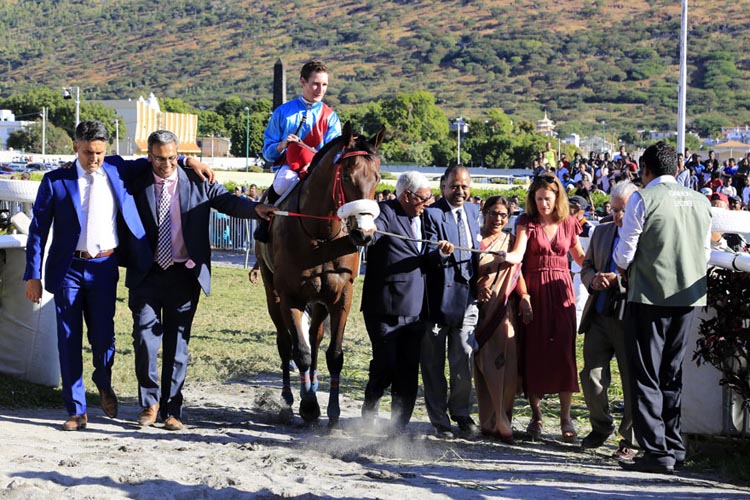 Table Bay (with Daniel Stackhouse) led in triumph by the Gujadhur family.