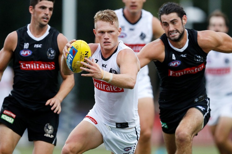 ADAM TRELOAR of the Magpies runs with the ball during the Collingwood Magpies AFL Intra Club match at the Holden Centre in Melbourne, Australia.
