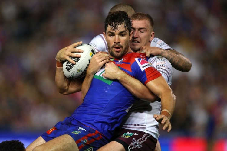 AIDAN GUERRA of the Knights is tackled during the NRL match between the Newcastle Knights and the Manly Sea Eagles at McDonald Jones Stadium in Newcastle, Australia.