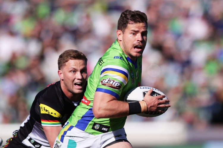 AIDAN SEZER of the Raiders gets away from MATTHEW MOYLAN of the Panthers during the NRL match between the Canberra Raiders and the Penrith Panthers at GIO Stadium in Canberra, Australia.