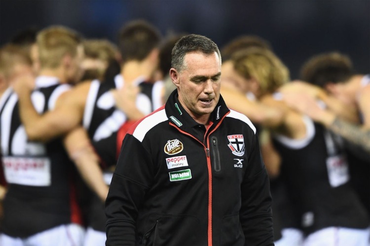 Saints head coach ALAN RICHARDSON walks away from talking to his players during the AFL match between the North Melbourne Kangaroos and the St Kilda Saints at Etihad Stadium in Melbourne, Australia.