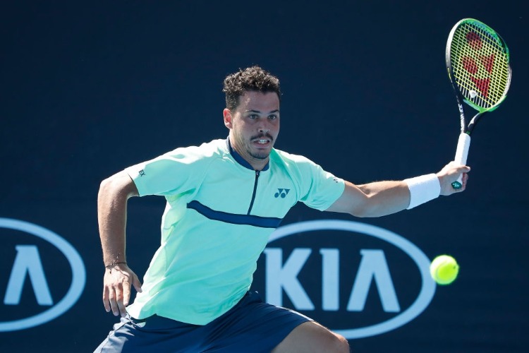 ALEX BOLT of Australia plays a forehand in his first round match against Viktor Troicki of Serbia of the 2018 Australian Open at Melbourne Park in Melbourne, Australia.