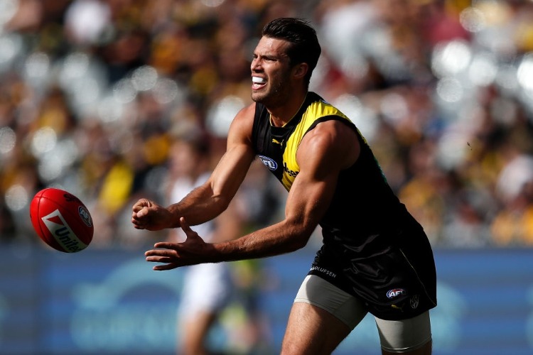 ALEX RANCE of the Tigers handpasses the ball during the 2018 AFL match between the Richmond Tigers and the Fremantle Dockers at the MCG in Melbourne, Australia.