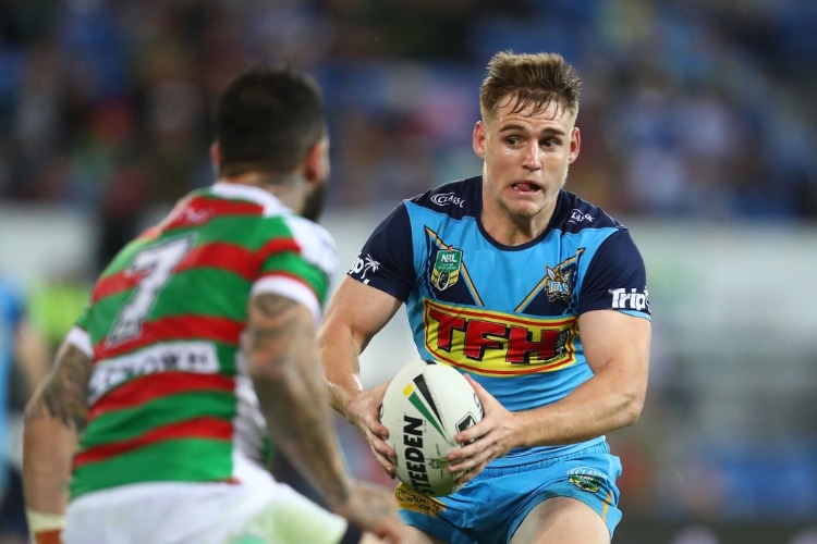 ALEXANDER BRIMSON of the Titans is tackled during the NRL match between the Gold Coast Titans and the South Sydney Rabbitohs at Cbus Super Stadium in Gold Coast, Australia.