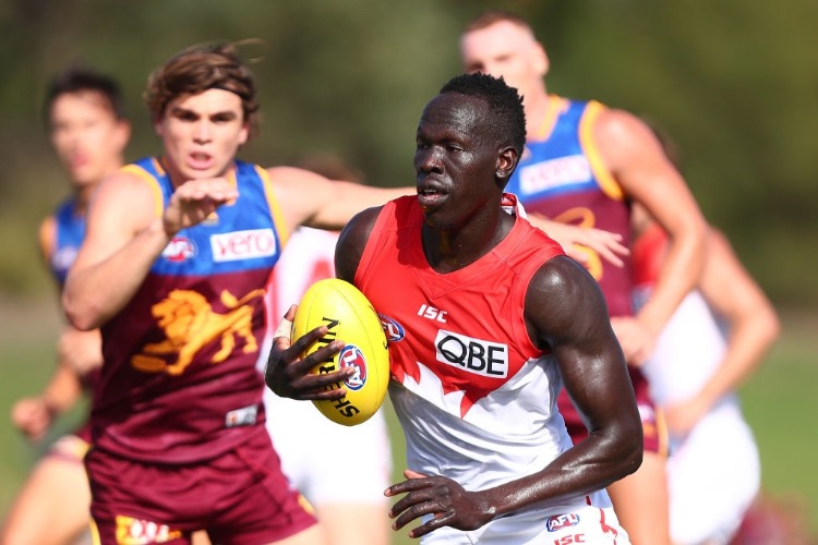ALIIR ALIIR of the Swans runs the ball during the AFL JLT Community Series match between the Brisbane Lions and the Sydney Swans at Moreton Bay Central Sports Complex in Brisbane, Australia.
