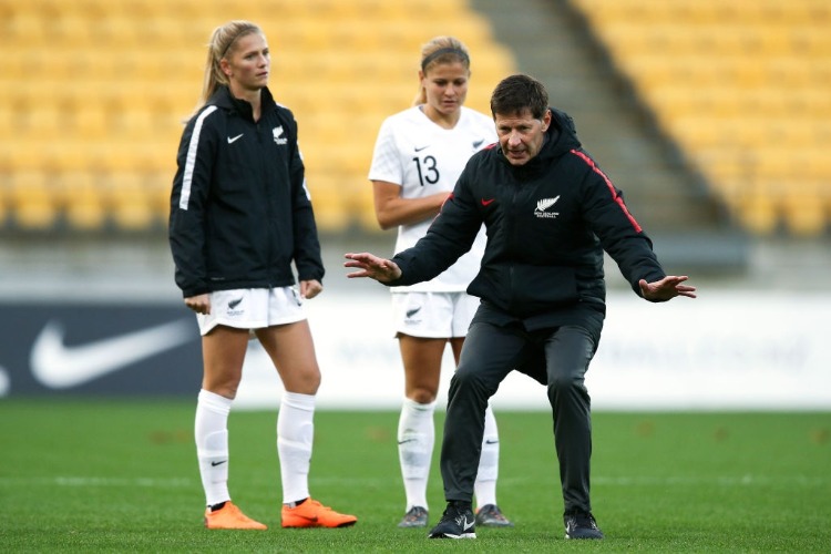 Coach ANDREAS HERAF of New Zealand demonstrates a move to Katie Bowen and Rosie White during the the New Zealand Football Ferns and Japan at Westpac Stadium in Wellington, New Zealand.