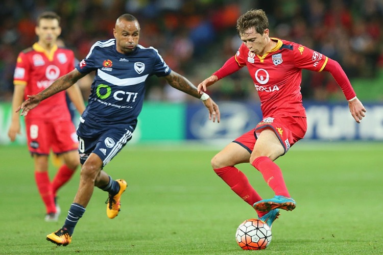 ARCHIE THOMPSON of the Victory and Craig Goodwin of United competes for the ball during the A-League match between Melbourne Victory and Adelaide United at AAMI Park in Melbourne, Australia.