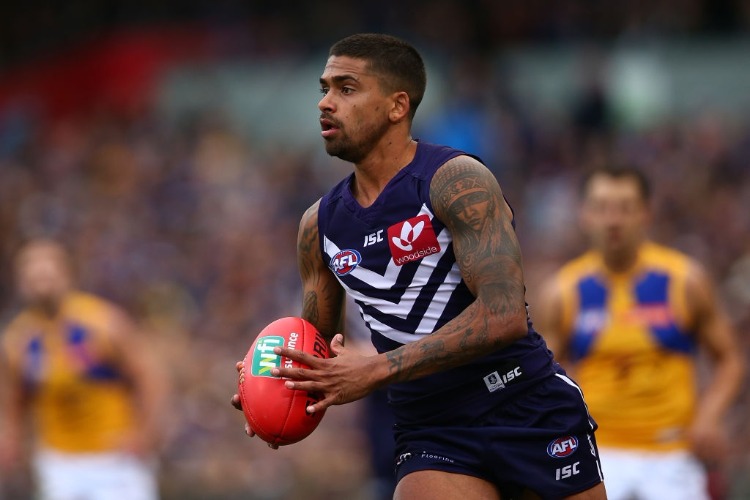BRADLEY HILL of the Dockers looks to pass the ball during the AFL match between the Fremantle Dockers and the West Coast Eagles at Domain Stadium in Perth, Australia.