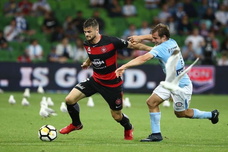 BRENDAN HAMILL of the Wanderers is challenged by NICK FITZGERALD of the City during the A-League match between Melbourne City and the Western Sydney Wanderers at AAMI Park in Melbourne, Australia.