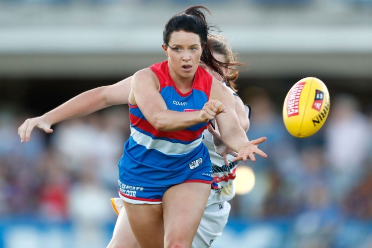 BROOKE LOCHLAND of the Bulldogs handpasses the ball during the 2017 AFLW match between the Western Bulldogs and the Adelaide Crows at VU Whitten Oval in Melbourne, Australia. BROOKE LOCHLAND of the Bulldogs handpasses the ball during the 2017 AFLW match between the Western Bulldogs and the Adelaide Crows at VU Whitten Oval in Melbourne, Australia.