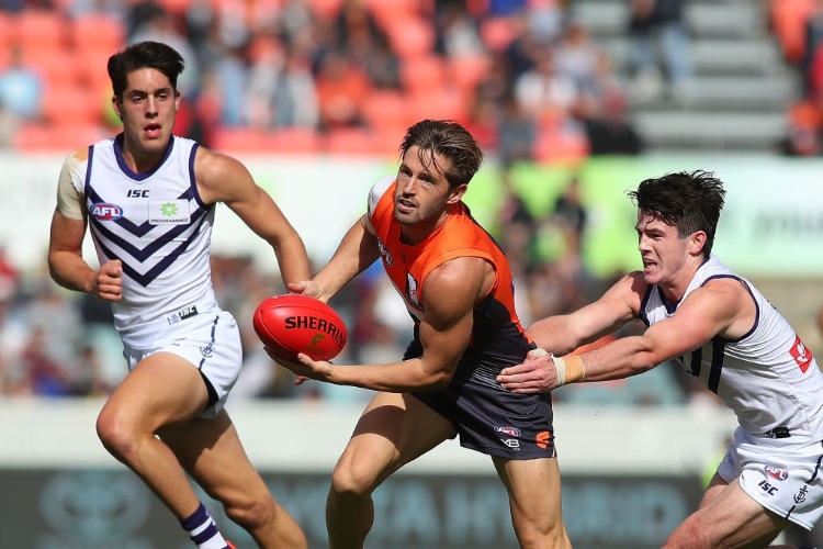 CALLAN WARD of the Dockers passes the ball during the AFL match between the Greater Western Sydney Giants and the Fremantle Dockers at UNSW Canberra Oval in Canberra, Australia.