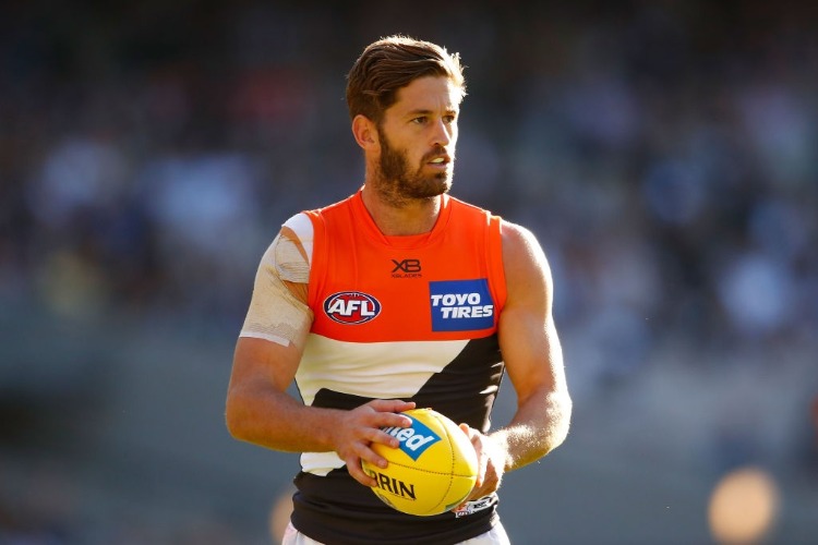 CALLAN WARD of the Giants runs with the ball during the AFL match between the Collingwood Magpies and the Greater Western Sydney Giants at MCG in Melbourne, Australia.