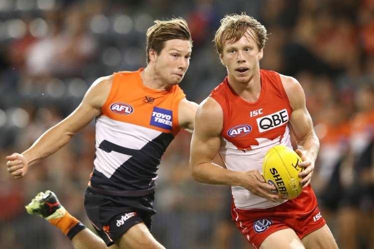 CALLUM MILLS of the Swans is tackled by TOBY GREENE of the Giants during the JLT Community Series AFL match between the Sydney Swans and the Greater Western Sydney Giants at Blacktown International Sportspark in Sydney, Australia.