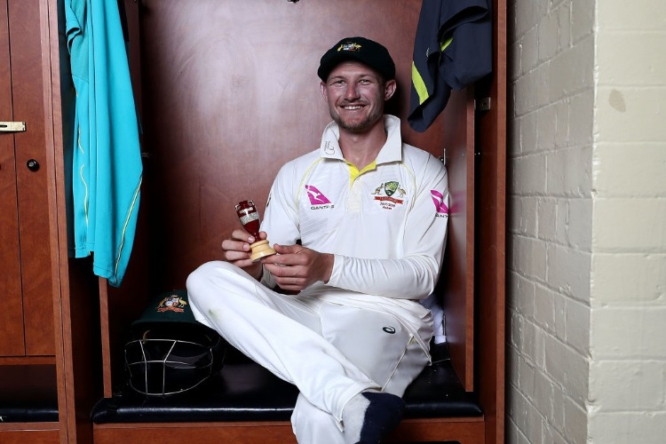 CAMERON BANCROFT of Australia celebrates with the Ashes Urn in the change room during the Fifth Test match in the 2017/18 Ashes Series between Australia and England at SCG in Sydney, Australia.
