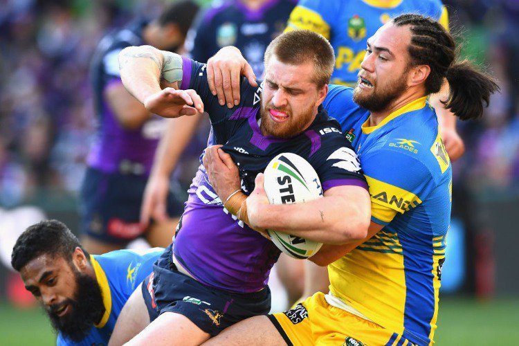 CAMERON MUNSTER of the Storm is tackled during the NRL Qualifying Final match between the Melbourne Storm and the Parramatta Eels at AAMI Park in Melbourne, Australia.