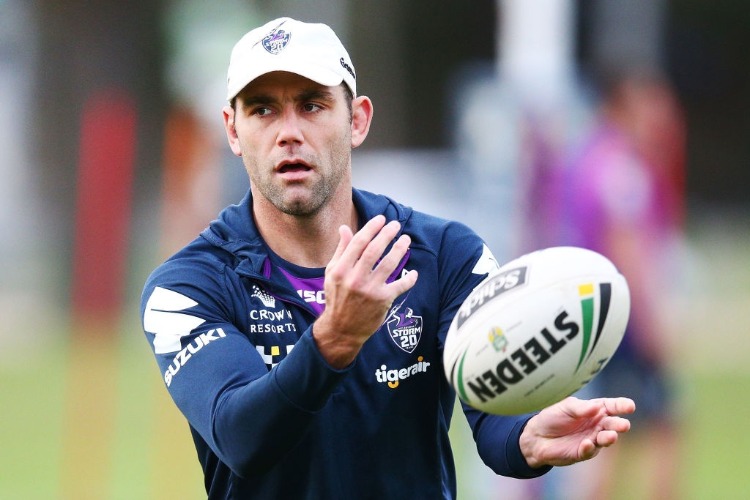 CAMERON SMITH of the Storm passes the ball during a Melbourne Storm NRL training session at AAMI Park in Melbourne, Australia.