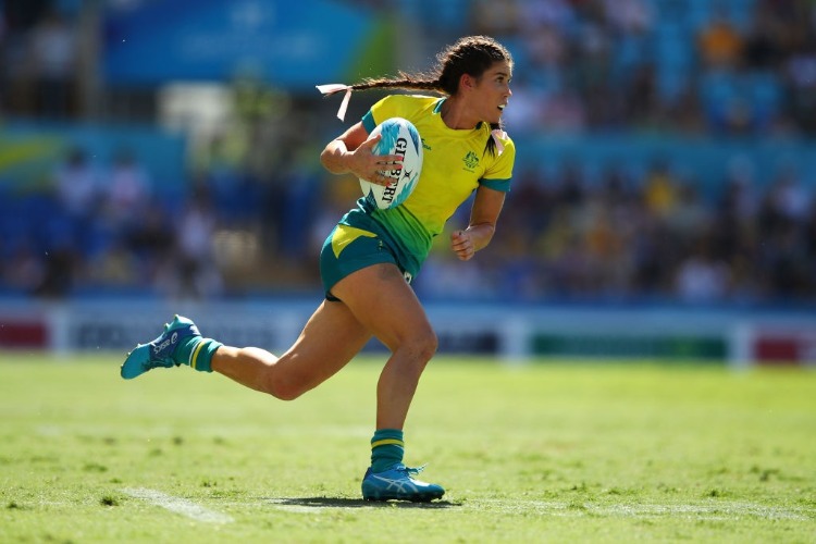 CHARLOTTE CASLICK of Australia runs during women's Rugby Sevens semi final match between Australia and Canada of the Gold Coast 2018 Commonwealth Games at Robina Stadium in the Gold Coast, Australia.