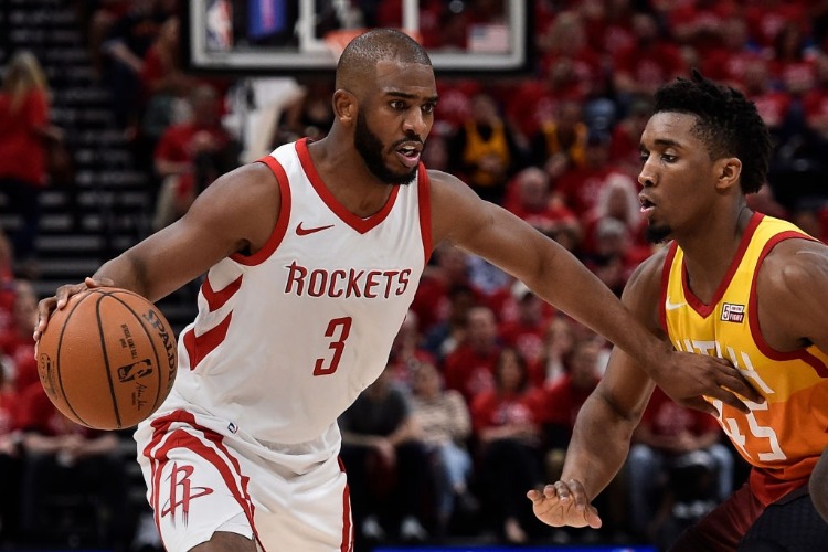 CHRIS PAUL #3 of the Houston Rockets drives past the defense of Donovan Mitchell #45 of the Utah Jazz during the 2018 NBA Playoffs at Vivint Smart Home Arena in Salt Lake City, Utah.