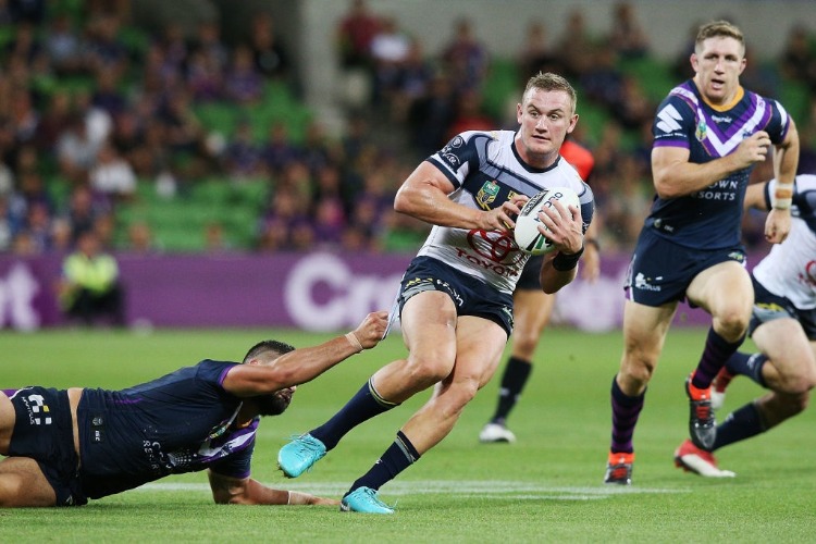 Jesse Bromwich of the Storm tackles COEN HESS of the Cowboys during the NRL match between the Melbourne Storm and the North Queensland Cowboys at AAMI Park in Melbourne, Australia.