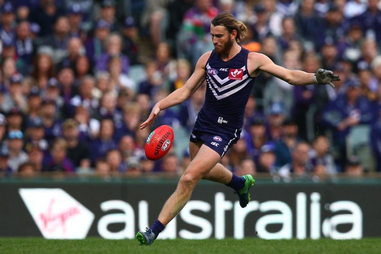 CONNOR BLAKELY of the Dockers kicks the ball during the AFL match between the Fremantle Dockers and the West Coast Eagles at Domain Stadium in Perth, Australia.