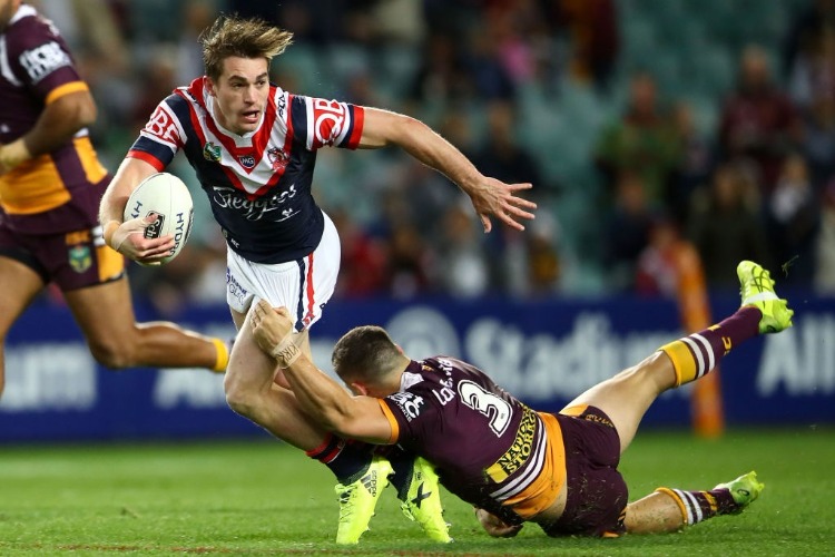 CONNOR WATSON of the Roosters is tackled by James Roberts of the Broncos during the NRL Qualifying Final match between the Sydney Roosters and the Brisbane Broncos at Allianz Stadium in Sydney, Australia.