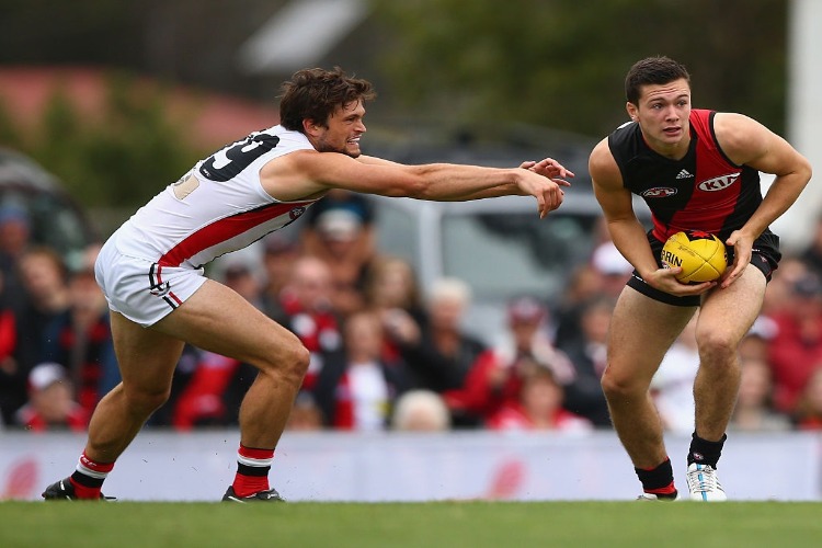 CONOR MCKENNA of the Bombers is pressured by CAMERON SHENTON of the Saints during the NAB Challenge AFL match between the Essendon Bombers and the St Kilda Saints at the Morwell Recreation Reserve in Morwell, Australia.