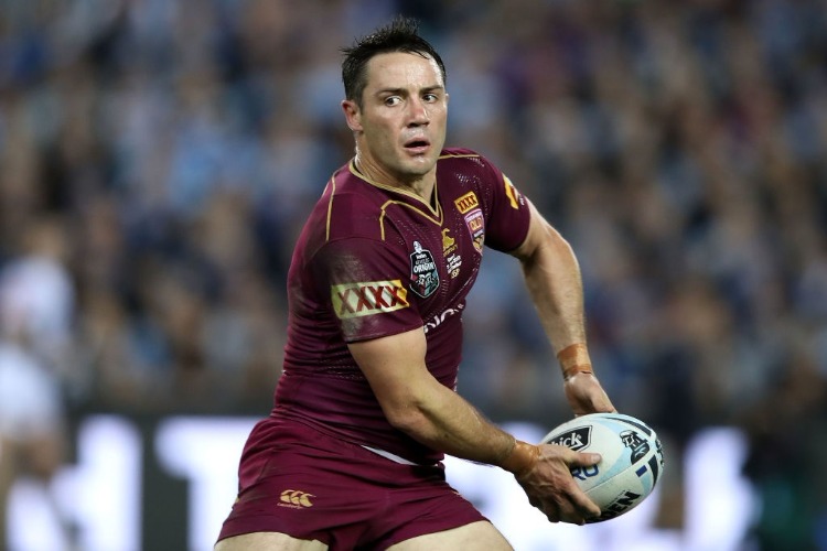 COOPER CRONK of the Maroons passes the ball during the State Of Origin series between the New South Wales Blues and the Queensland Maroons at ANZ Stadium in Sydney, Australia.