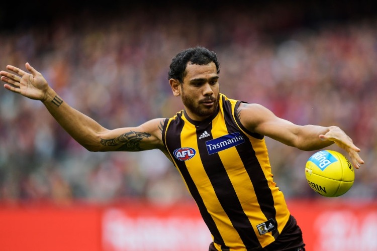 CYRIL RIOLI of the Hawks kicks the ball during the AFL match between the Hawthorn Hawks and the Melbourne Demons at MCG in Melbourne, Australia.