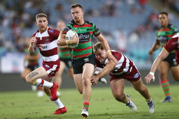 DAMIEN COOK of the Rabbitohs makes a break during the NRL trial match between the South Sydney Rabbitohs and Wigan at ANZ Stadium Sydney in Sydney, Australia.