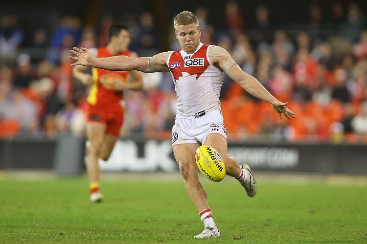 DAN HANNEBERY of the Swans kicks during the AFL match between the Gold Coast Suns and the Sydney Swans at Metricon Stadium in Gold Coast, Australia.